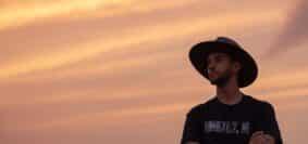 man in black cowboy hat and black crew neck t-shirt