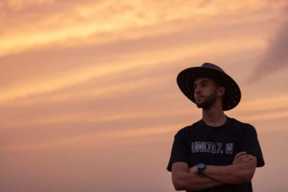 man in black cowboy hat and black crew neck t-shirt