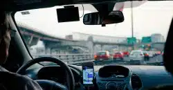 man driving vehicle with GPS system turned on