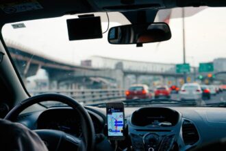 man driving vehicle with GPS system turned on